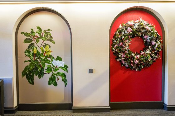 A mural inset in an arch of a magnolia branch flowers.